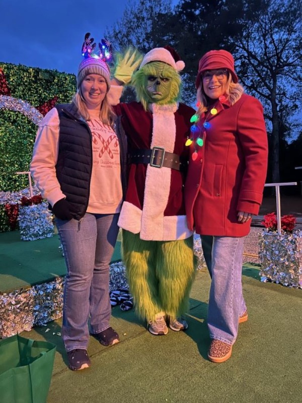 Marketing department with the Grinch on parade float